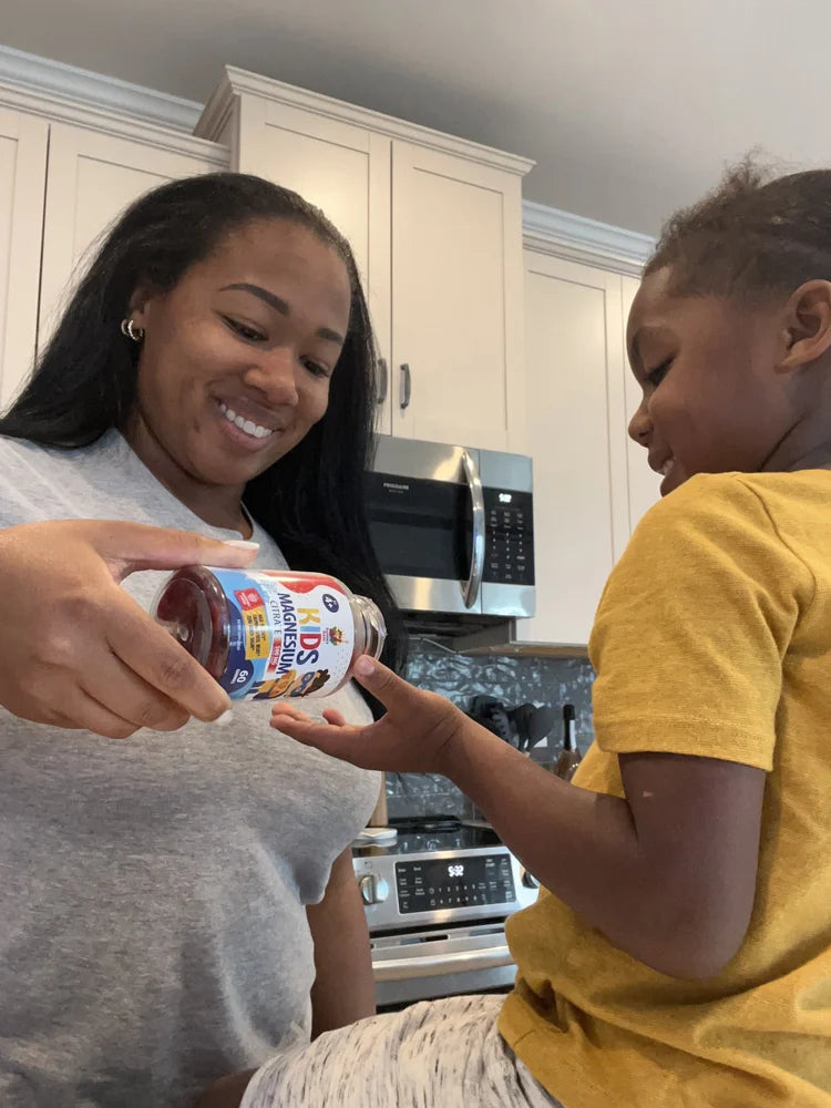 Parent and child with a Sunny Sam Kids Magnesium bottle.