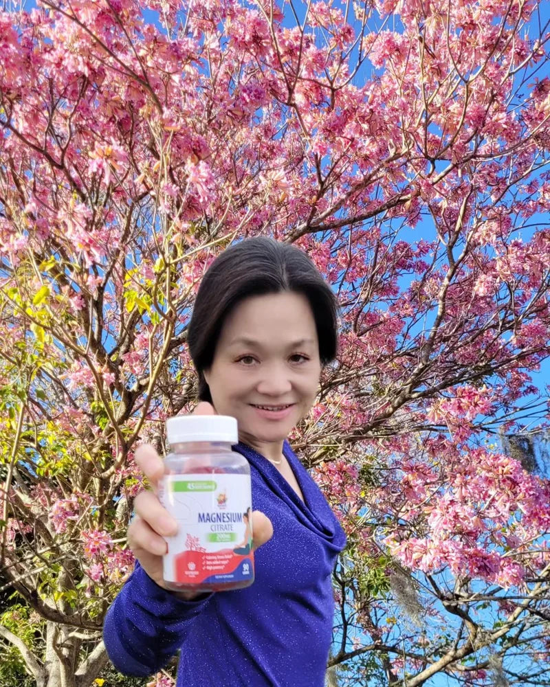 Community member holding a Sunny Sam Kids Iron bottle outdoors.