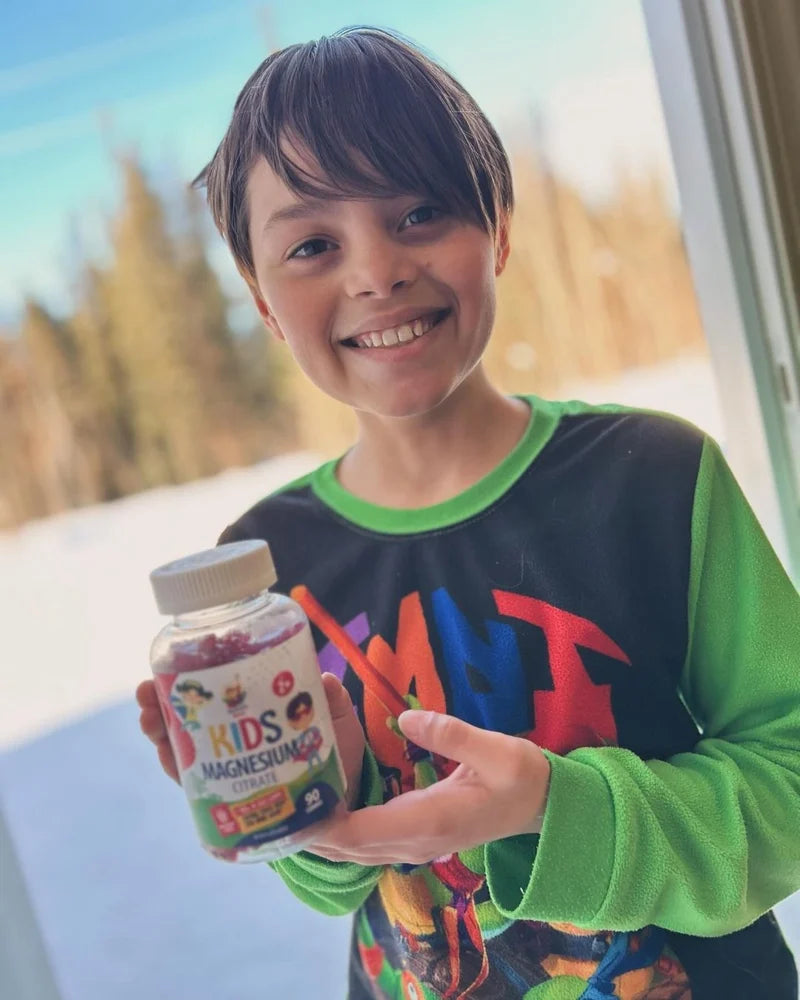 Child holding a Sunny Sam Kids Magnesium bottle.